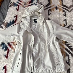 It’s a North Face waterproof jacket, the color is a off white, size medium.